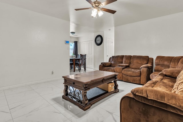 living area with marble finish floor, baseboards, and ceiling fan