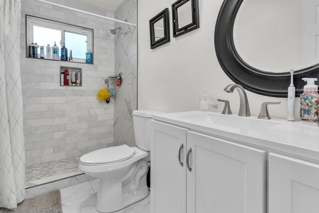 full bath with toilet, marble finish floor, vanity, and a tile shower