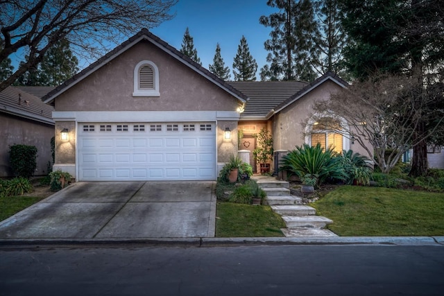 view of front of home featuring a garage and a lawn