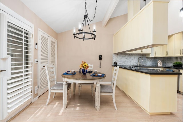 dining area featuring vaulted ceiling with beams, a notable chandelier, and light wood-type flooring