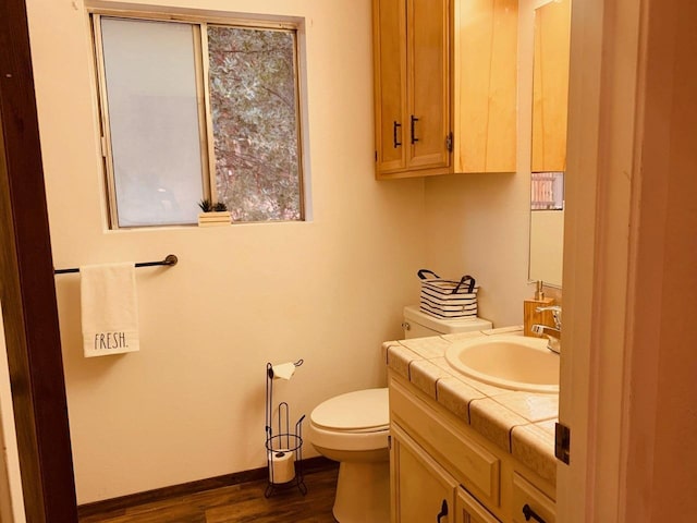 bathroom featuring vanity, hardwood / wood-style floors, and toilet