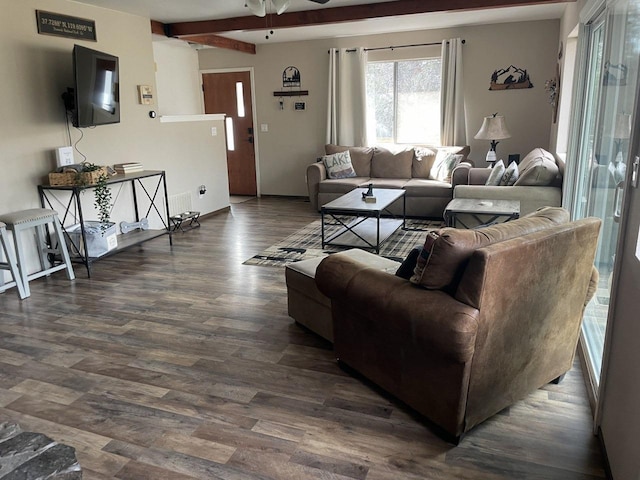 living room with dark wood-type flooring, ceiling fan, and beam ceiling