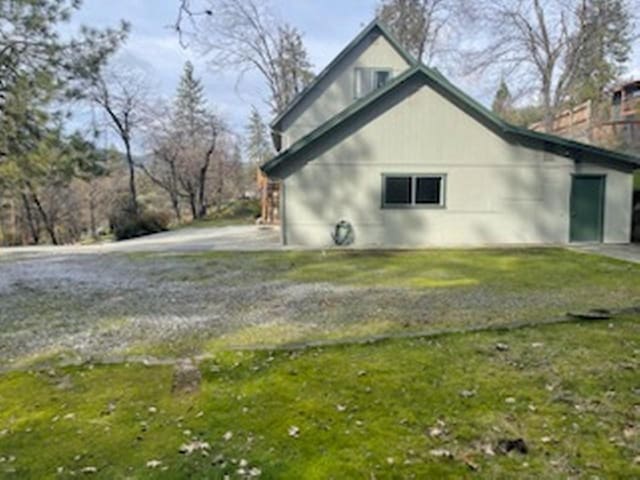 view of property exterior featuring a lawn