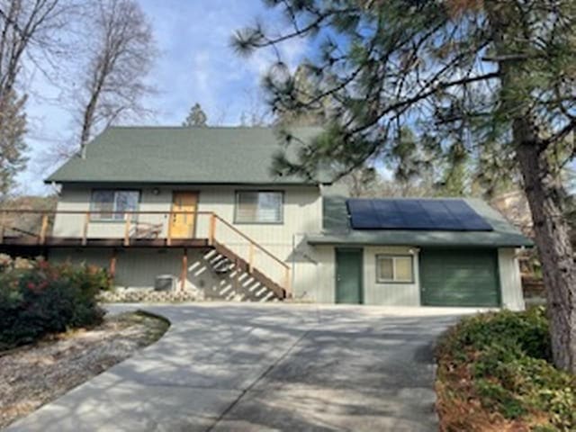 view of front of home with solar panels and a deck