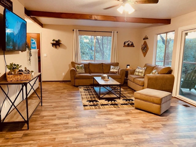 living room with beam ceiling, light hardwood / wood-style flooring, and ceiling fan