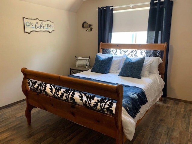 bedroom featuring vaulted ceiling and dark hardwood / wood-style flooring