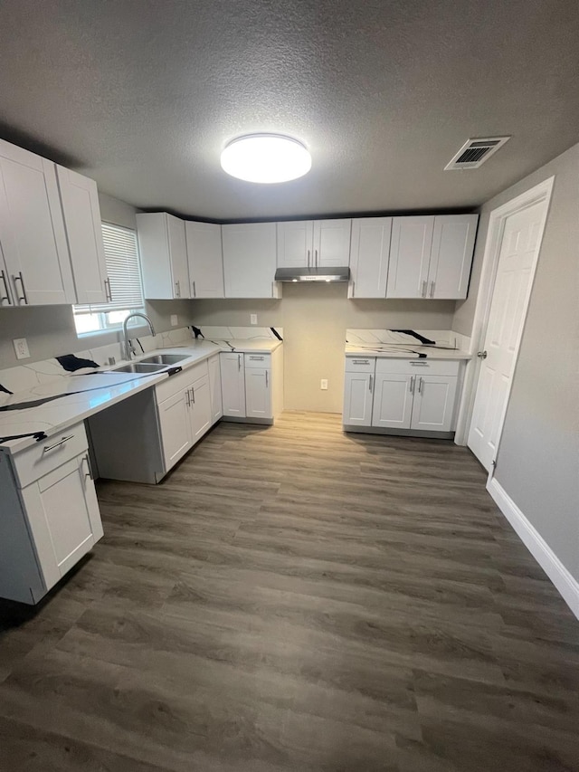 kitchen with sink, a textured ceiling, white cabinets, and dark hardwood / wood-style flooring