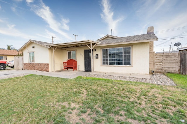 ranch-style house with a patio and a front yard