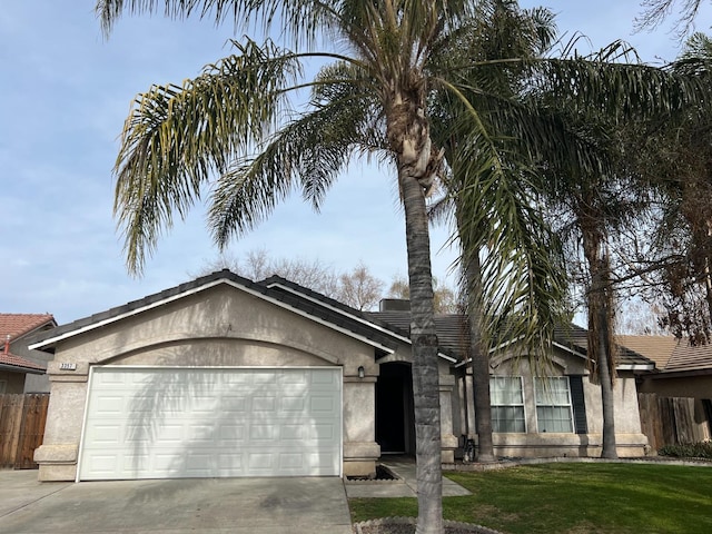 single story home featuring a garage and a front yard