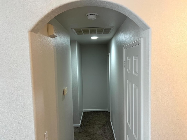 corridor with dark colored carpet