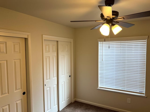 unfurnished bedroom with ceiling fan and carpet flooring