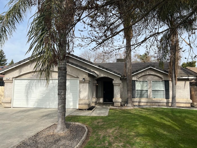 ranch-style house featuring a garage and a front yard