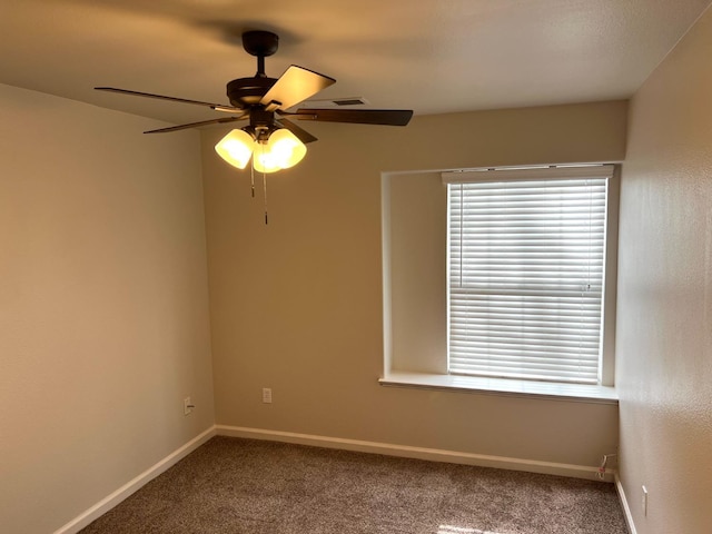 spare room with plenty of natural light, ceiling fan, and carpet flooring