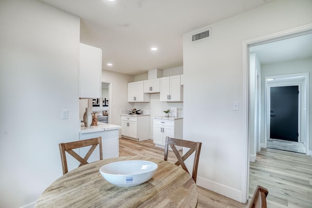 dining area with light wood-type flooring