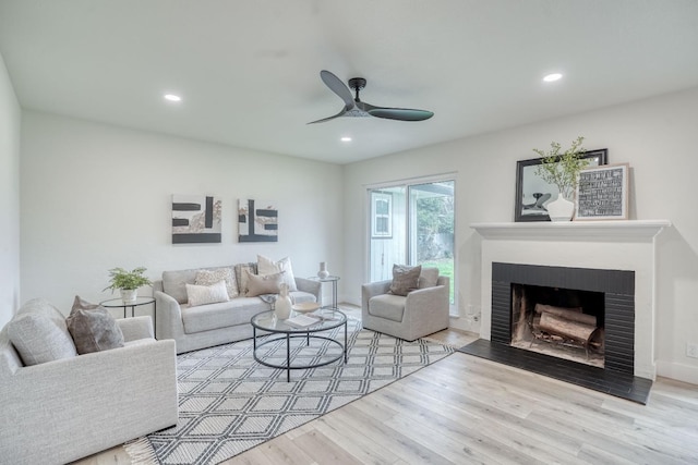 living room with light hardwood / wood-style flooring and ceiling fan