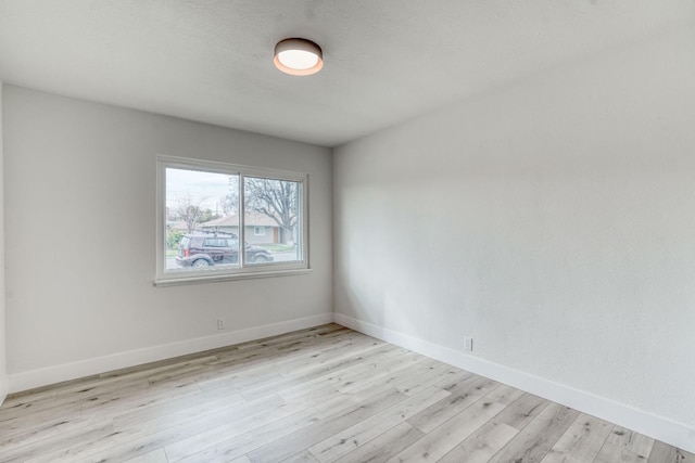 spare room with light hardwood / wood-style flooring