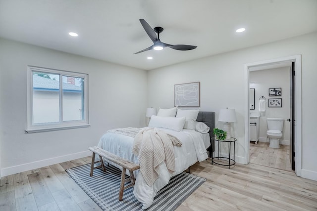 bedroom with ceiling fan, ensuite bath, and light hardwood / wood-style floors