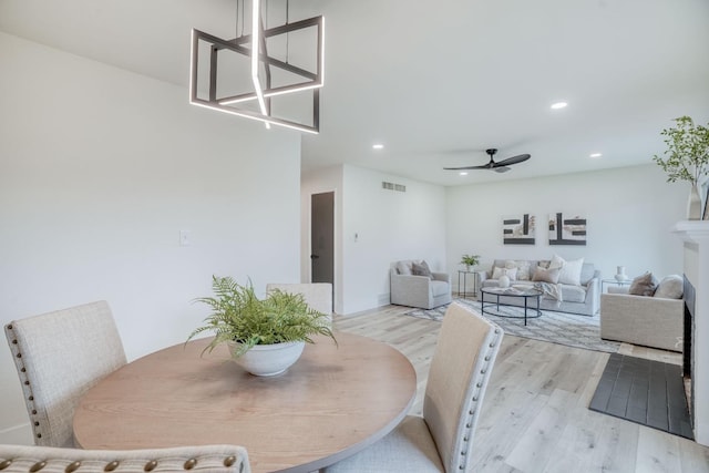 dining room with ceiling fan and light hardwood / wood-style flooring