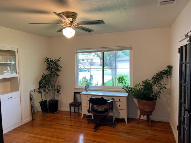 office space featuring hardwood / wood-style flooring and ceiling fan