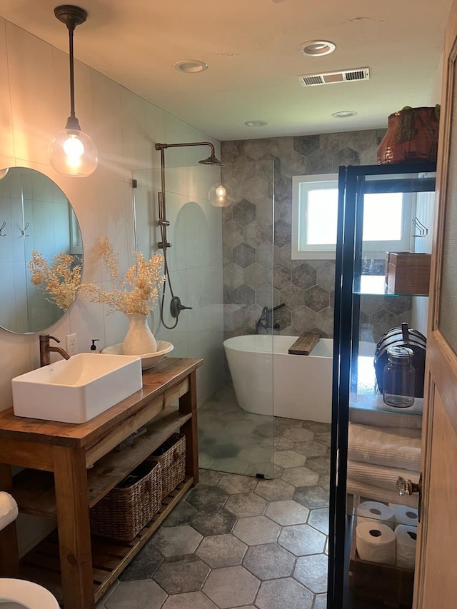 bathroom with vanity and separate shower and tub