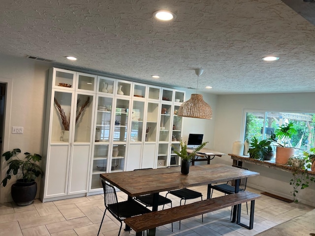 dining area featuring a textured ceiling