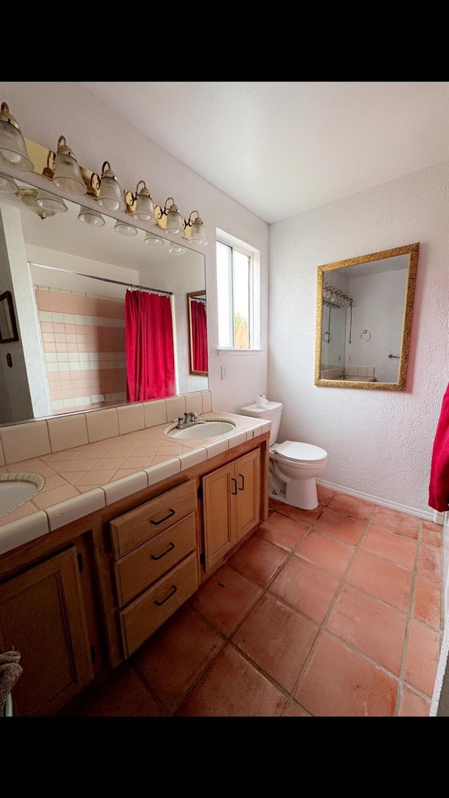 bathroom featuring vanity, a shower with curtain, tile patterned floors, and toilet