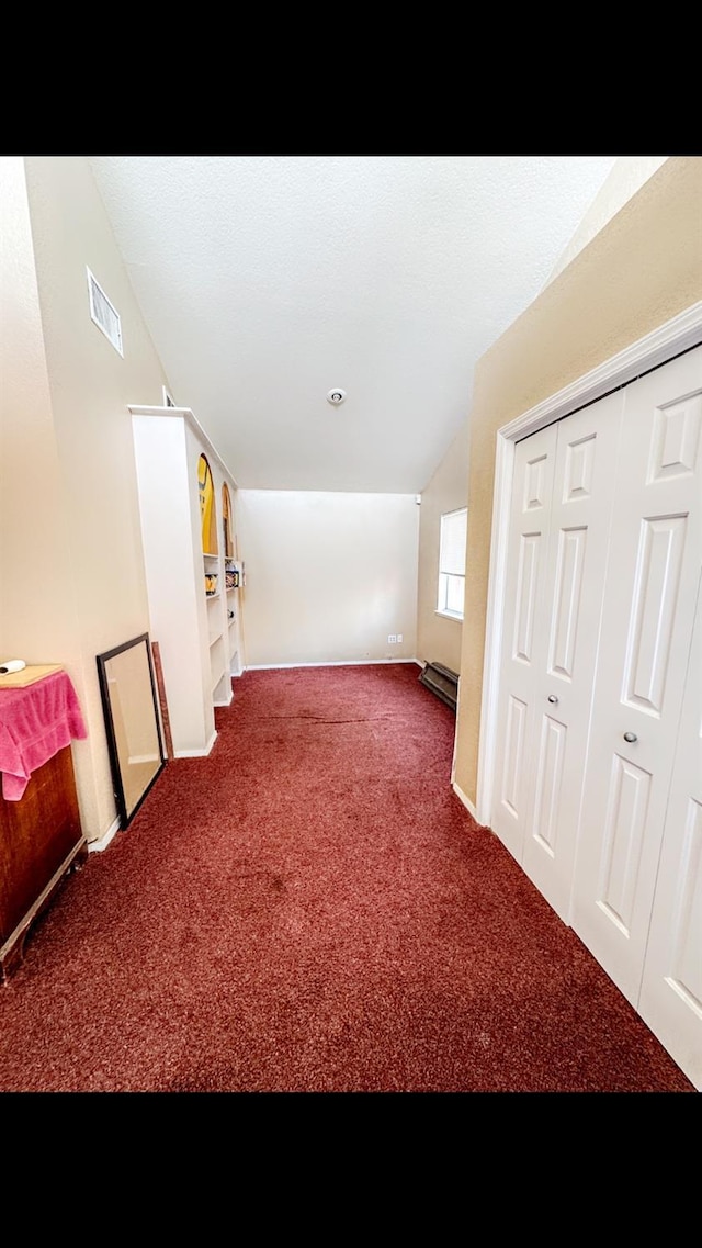 bonus room featuring lofted ceiling and carpet flooring