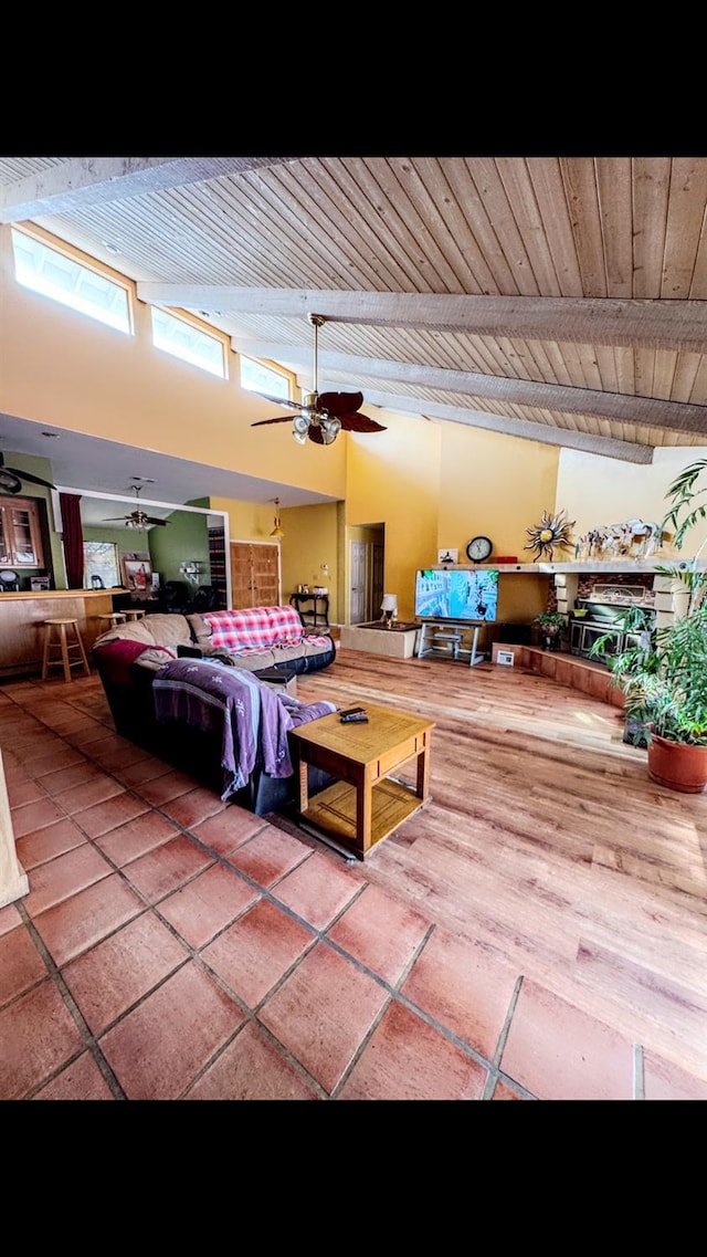 interior space with wood ceiling, ceiling fan, and a towering ceiling