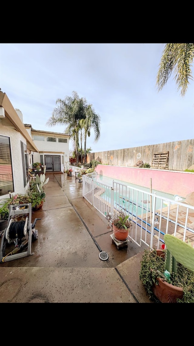 view of patio / terrace with a fenced in pool