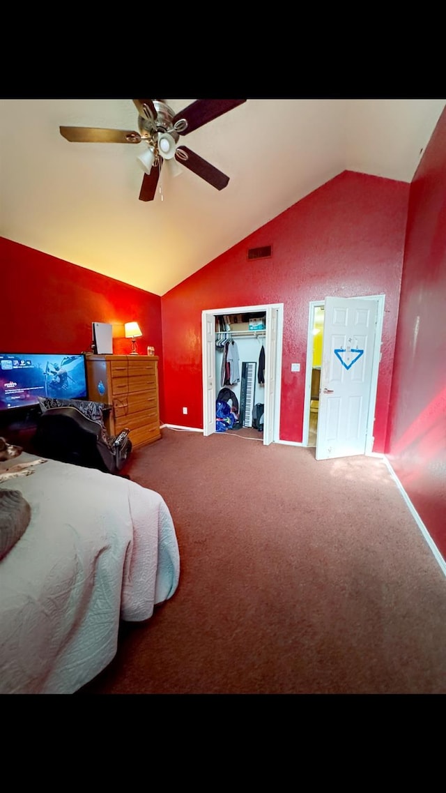 carpeted bedroom with vaulted ceiling and ceiling fan