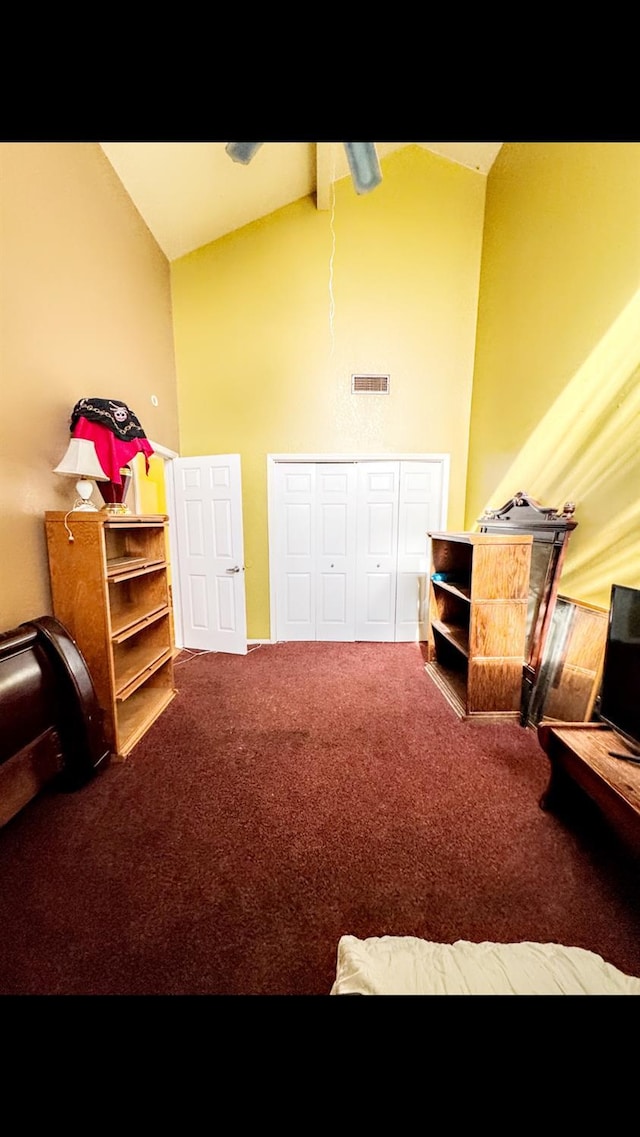 interior space featuring carpet floors and high vaulted ceiling