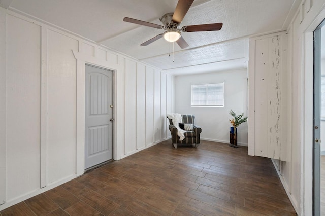 unfurnished room with dark wood-type flooring and ceiling fan