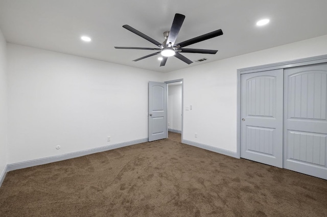 unfurnished bedroom with carpet flooring, ceiling fan, and a closet