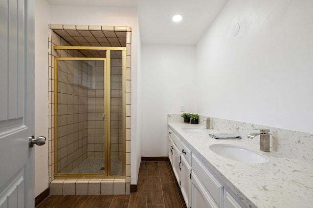 bathroom featuring walk in shower and vanity