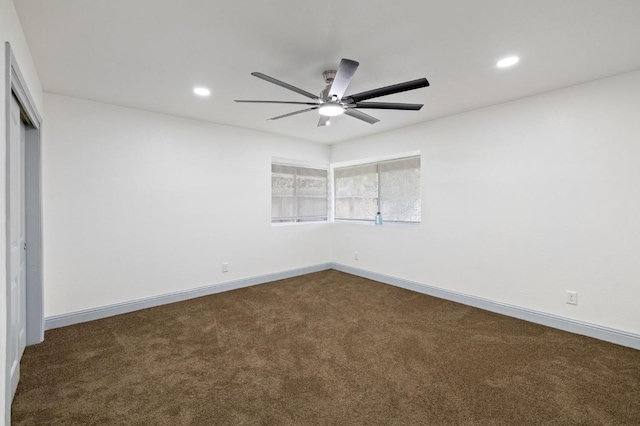 unfurnished bedroom featuring dark carpet, a closet, and ceiling fan