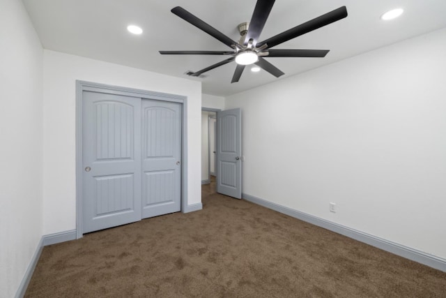 unfurnished bedroom with a closet, ceiling fan, and carpet flooring