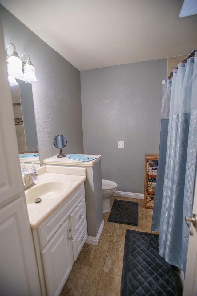 bathroom with vanity, tile patterned floors, and toilet