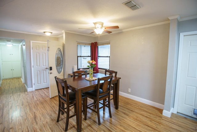 dining room featuring ornamental molding, light hardwood / wood-style floors, and ceiling fan