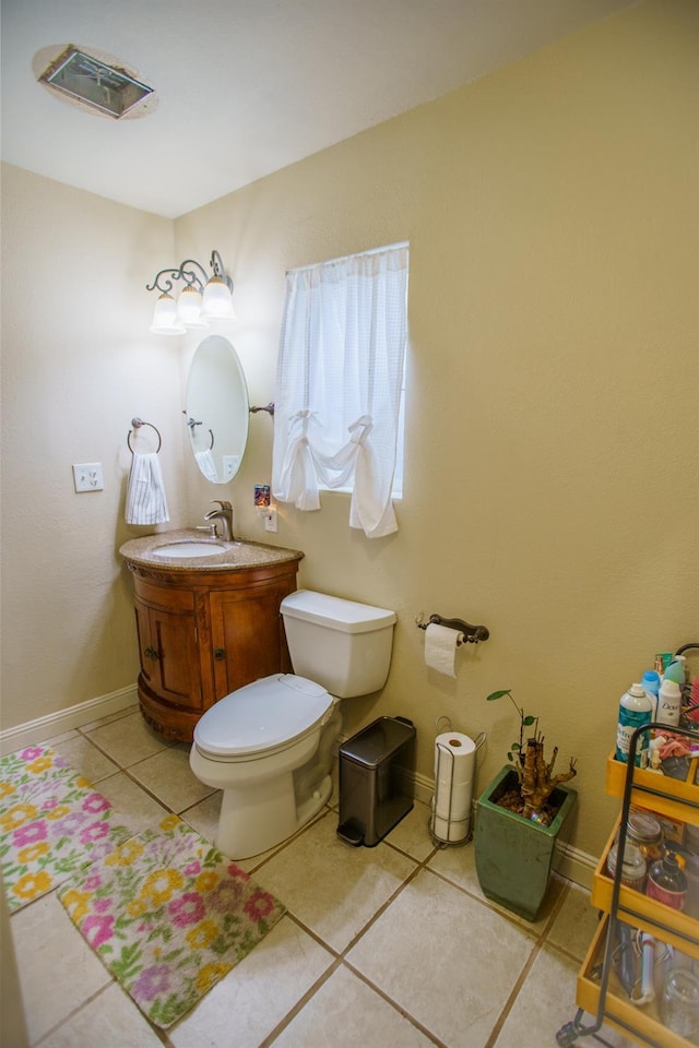 bathroom with tile patterned flooring, vanity, and toilet