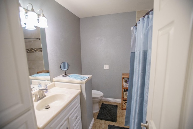 bathroom with vanity, toilet, and tile patterned flooring