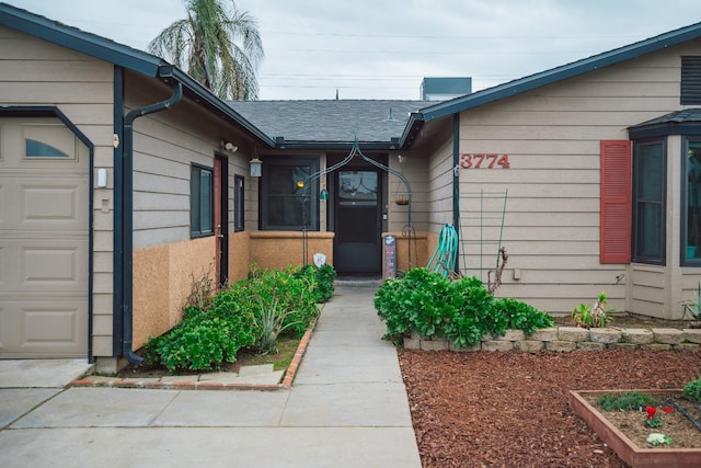 view of exterior entry with a garage