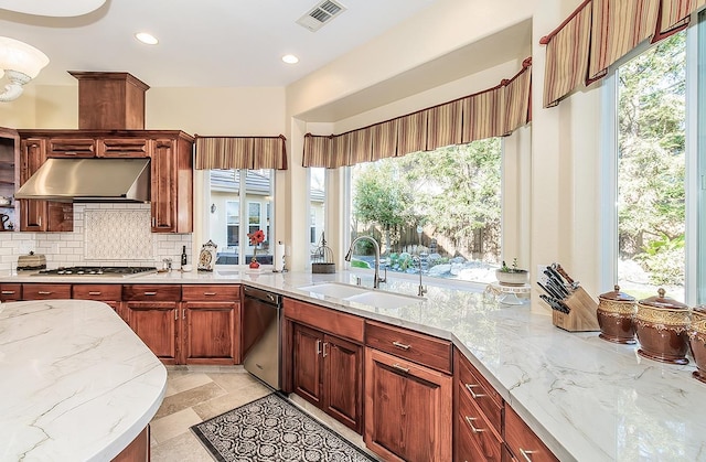 kitchen with sink, dishwasher, light stone countertops, decorative backsplash, and stainless steel gas stovetop