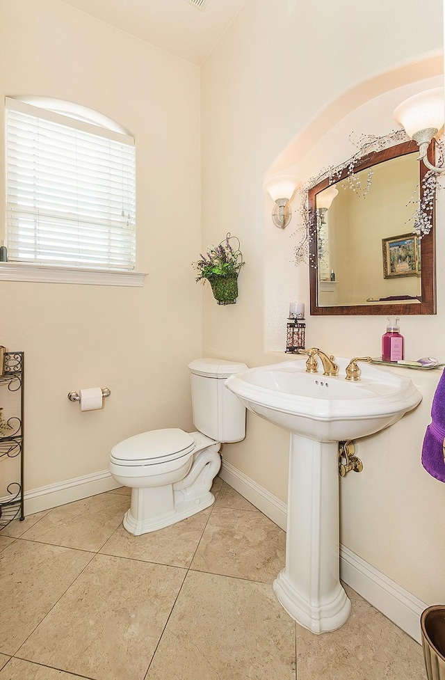 bathroom with tile patterned flooring and toilet