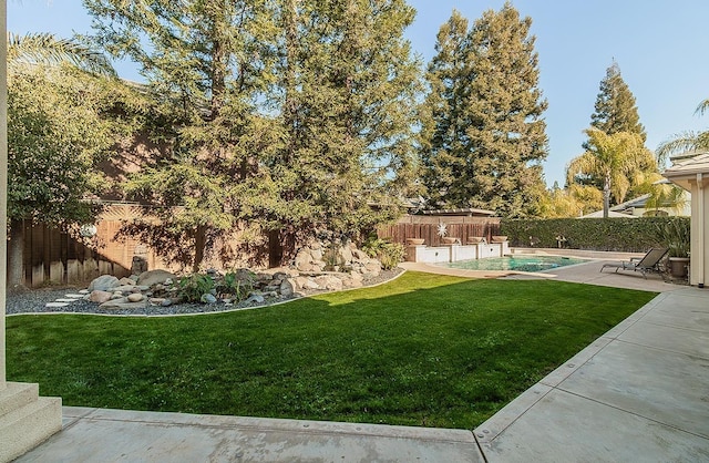 view of yard with a fenced in pool and a patio area