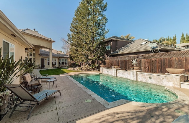 view of swimming pool with a patio