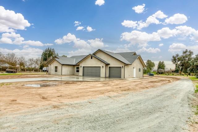 35710 Bonadelle Ave, Madera, CA 93636 - view of front of property with a garage, dirt driveway, and stucco siding