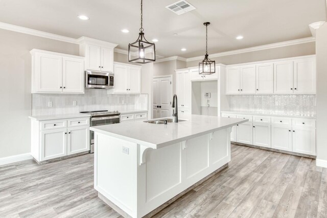 35710 Bonadelle Ave, Madera, CA 93636 - kitchen with a sink, a center island with sink, visible vents, decorative backsplash, and appliances with stainless steel finishes