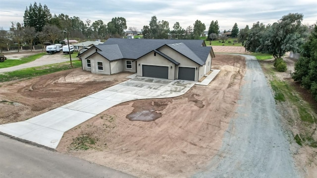 35710 Bonadelle Ave, Madera, CA 93636 - view of front facade with stucco siding, roof with shingles, concrete driveway, and a garage