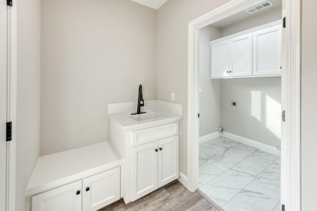 35710 Bonadelle Ave, Madera, CA 93636 - washroom with marble finish floor, visible vents, hookup for an electric dryer, a sink, and cabinet space