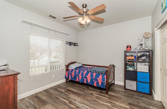 bedroom with dark wood-type flooring and ceiling fan